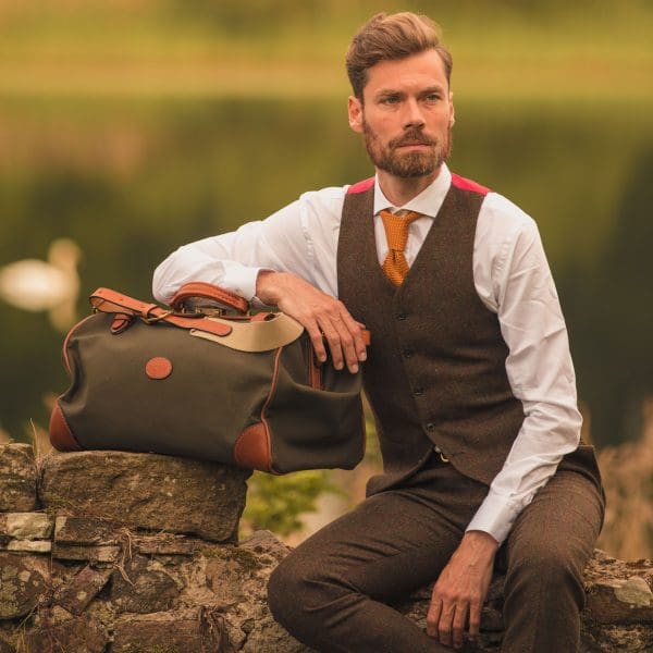 Waterproof travel bag in canvas & leather weekend in forest green colour, handmade by Mackenzie Leather Edinburgh.